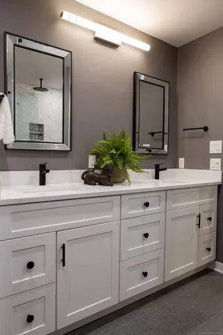 a bathroom with vanity mirror and
