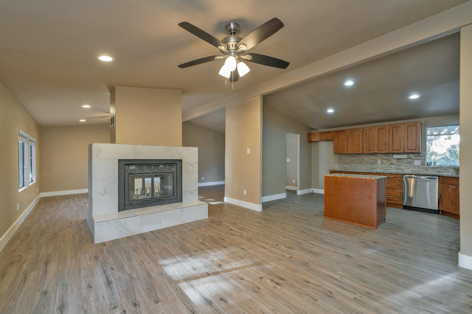 4420 Pleasant Valley Road, Unit 155 Diamond Springs, CA 95619 - Photo 8 of 42 an open kitchen with fireplace and wooden floor