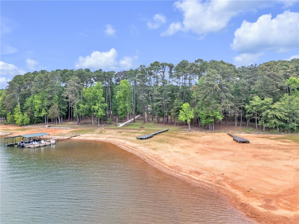 4416 Denver Cove Road Anderson, SC 29625 - Photo 29 of 31 A tranquil lakeside retreat with a private boat dock and sandy beach, perfect for waterside enjoyment.