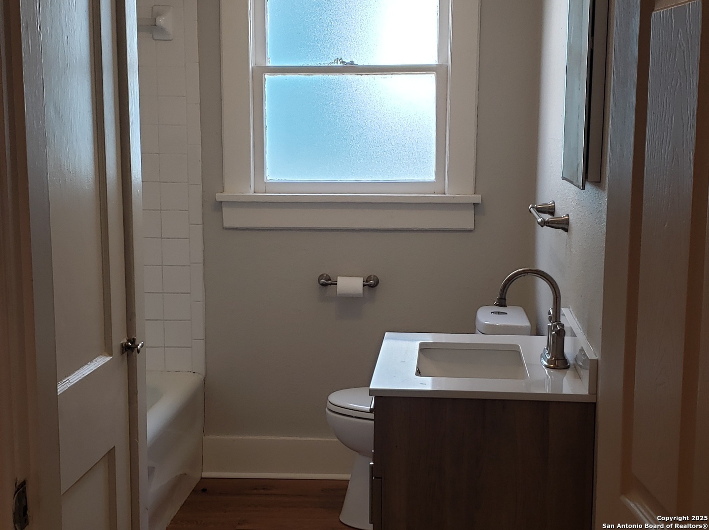 1406 Hicks Avenue San Antonio, TX 78210 - Photo 12 of 14 a bathroom with a sink a toilet and window