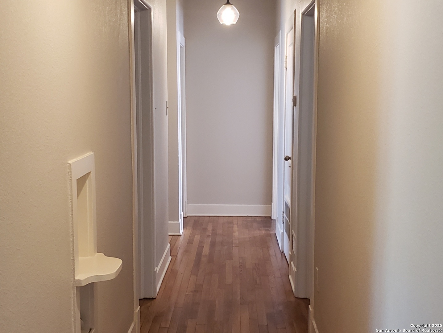 1406 Hicks Avenue San Antonio, TX 78210 - Photo 13 of 14 a view of a hallway with wooden floor