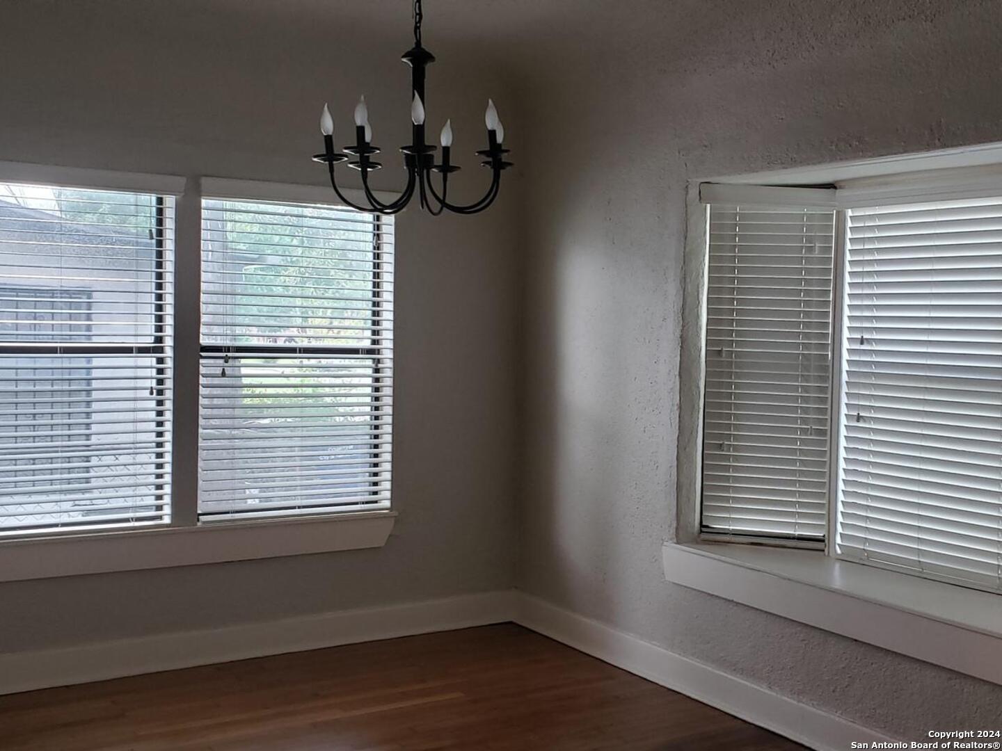 1406 Hicks Avenue San Antonio, TX 78210 - Photo 9 of 14 a view of a room with a window and wooden floor