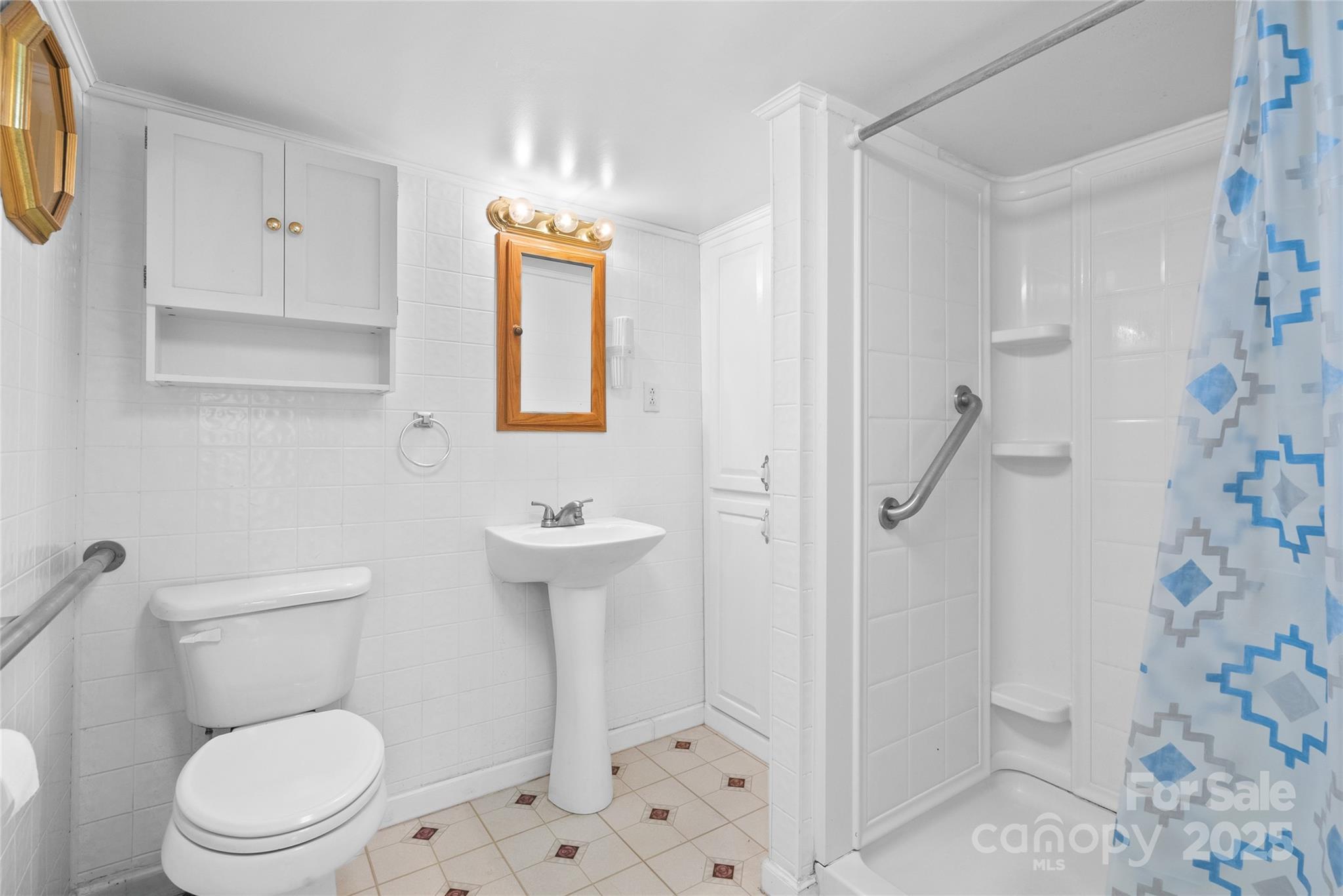 841 Elm Bend Road Brevard, NC 28712 - Photo 13 of 26 a white toilet sitting next to a bathroom sink