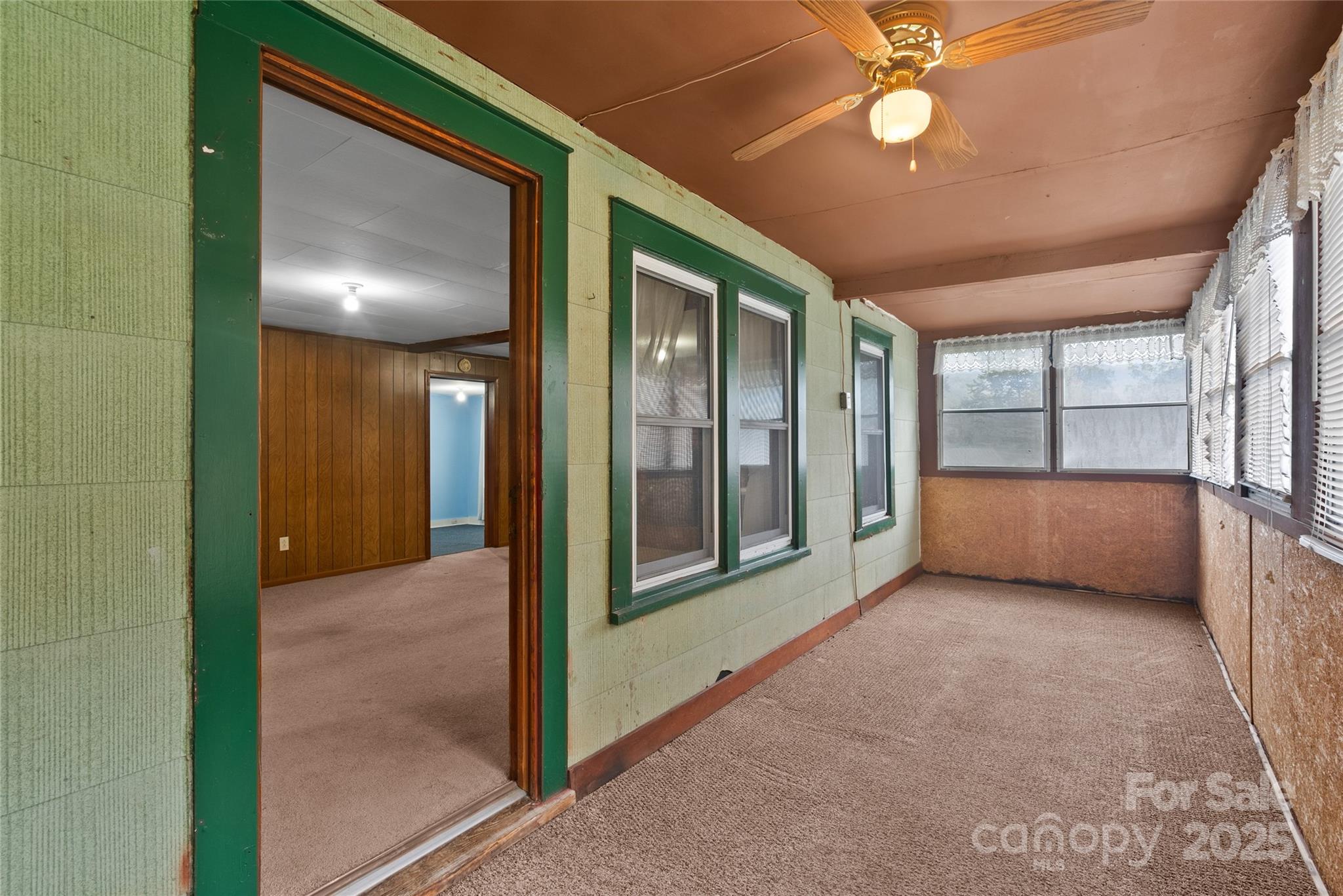 841 Elm Bend Road Brevard, NC 28712 - Photo 8 of 26 a view of a hallway with a big room and chandelier fan