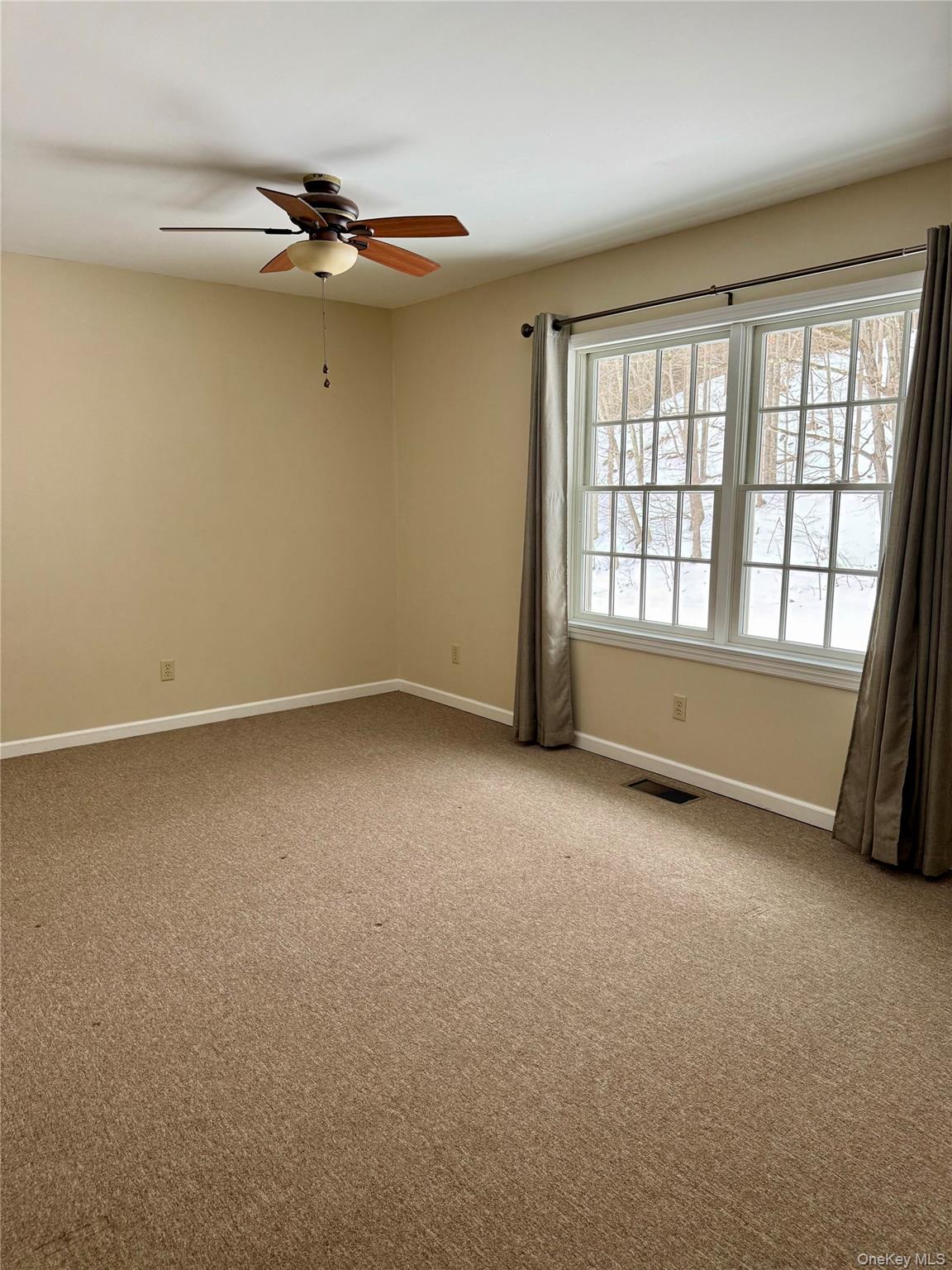 91-97 Sawmill Road Red Hook, NY 12571 - Photo 6 of 8 Empty room with light colored carpet and ceiling fan