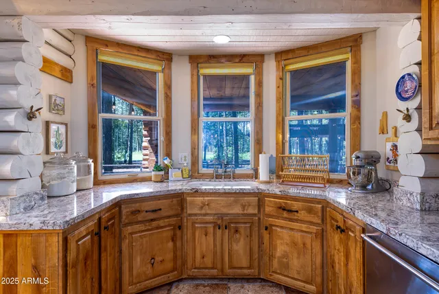 a kitchen with stainless steel appliances granite countertop sink stove and cabinets