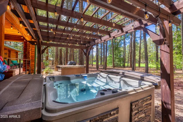 a view of a chair and tables in the patio next to a yard