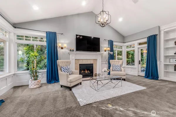 a living room with furniture a flat screen tv and a fireplace