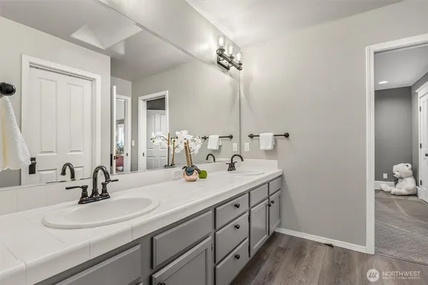 a bathroom with a double vanity sink and a mirror