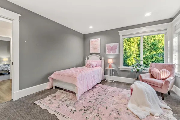 a bedroom with a large bed and a couch