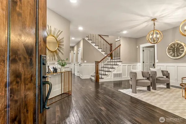 a view of a hallway with wooden floor and entryway