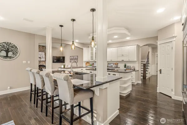 a large kitchen with a table and chairs