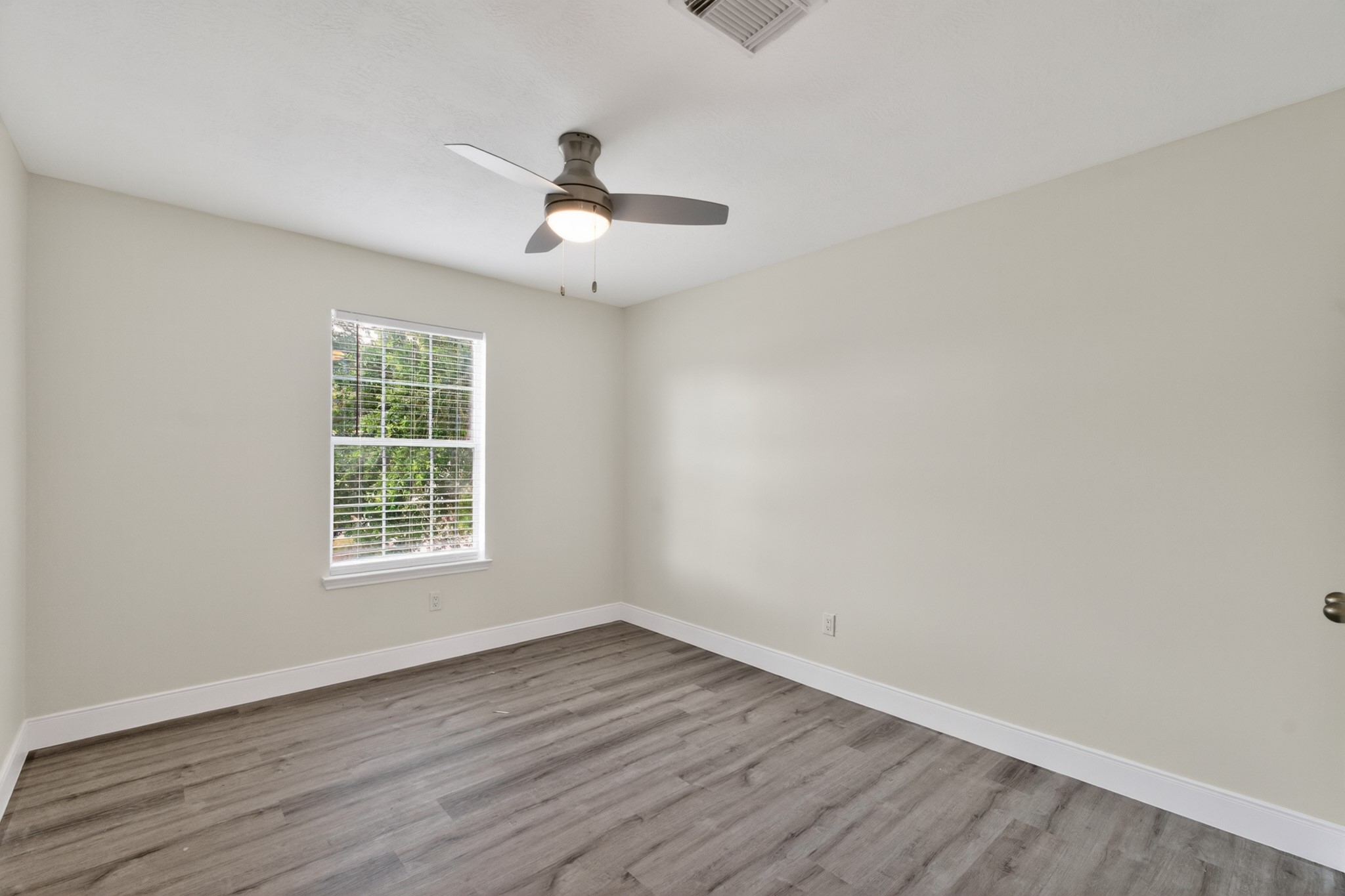 918 Ivycroft Lane Spring, TX 77373 - Photo 28 of 33 an empty room with wooden floor fan and windows