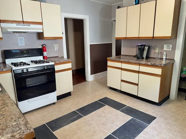 a kitchen with stainless steel appliances granite countertop a stove and a refrigerator