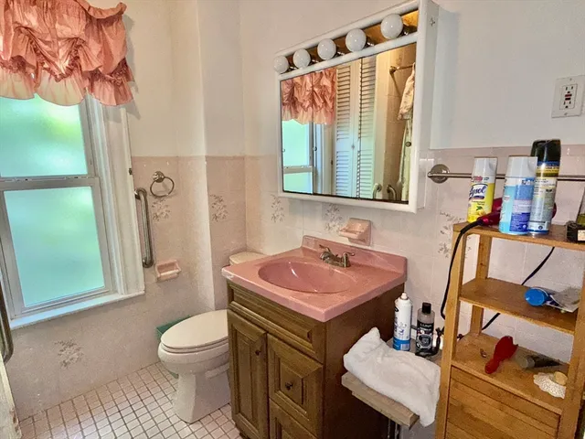 a bathroom with a sink toilet and mirror