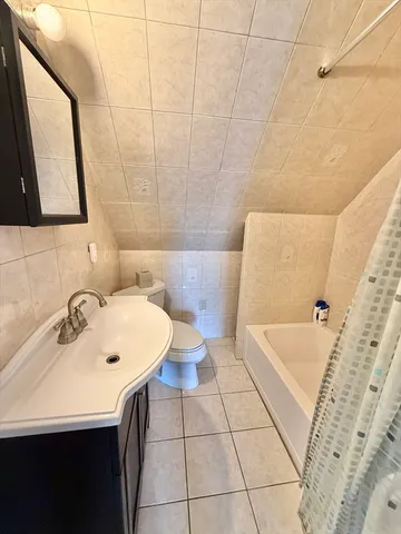 a bathroom with a sink a toilet and bathtub