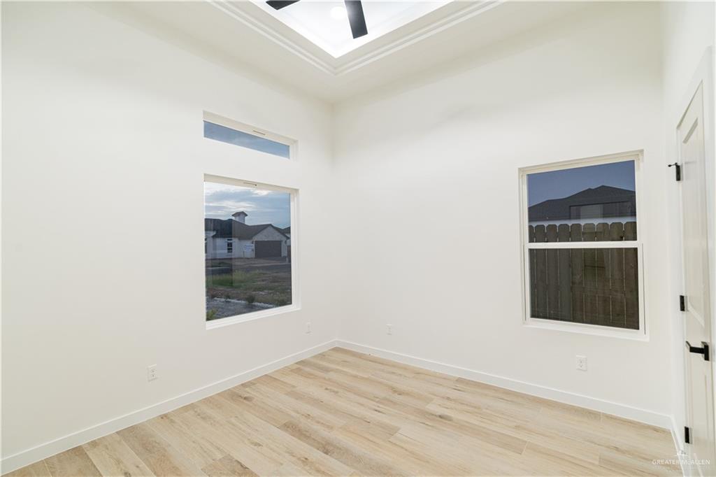 9804 North 25th Street McAllen, TX 78504 - Photo 8 of 18 a view of an empty room with wooden floor and a window