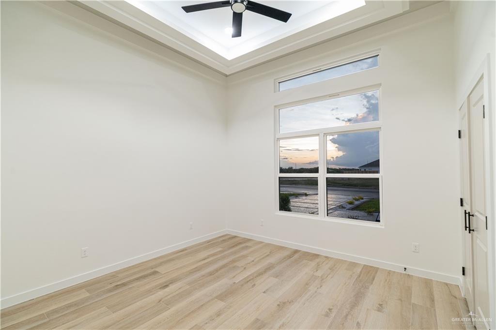 9804 North 25th Street McAllen, TX 78504 - Photo 9 of 18 an empty room with a window and a ceiling fan