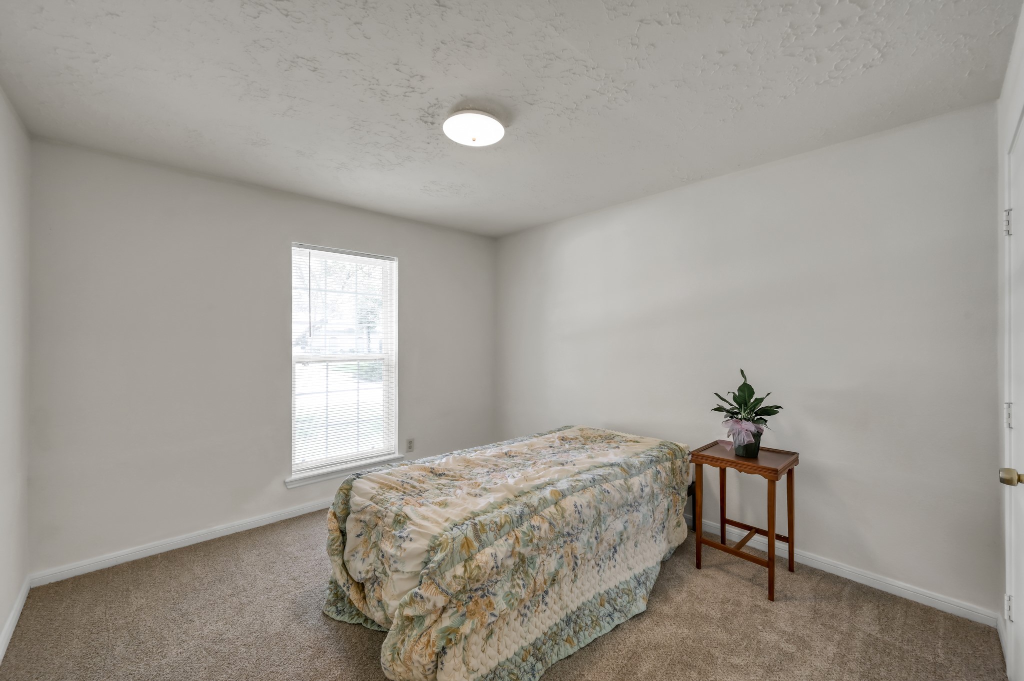 4314 Enchantedgate Drive Spring, TX 77373 - Photo 27 of 47 Guest bedroom with neutral walls and carpet. A window provides natural light, creating a bright and inviting space.