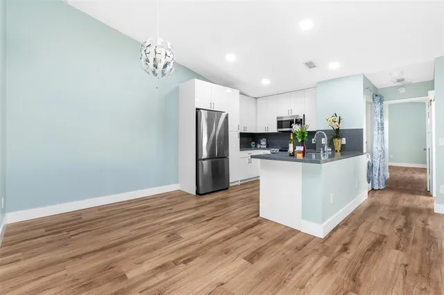 a kitchen with stainless steel appliances a refrigerator and a stove top oven