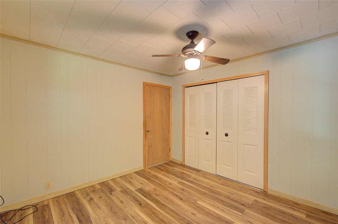 5064 Keowee School Road Seneca, SC 29672 - Photo 22 of 49 This inviting bedroom features rich wood flooring and practical closet space.