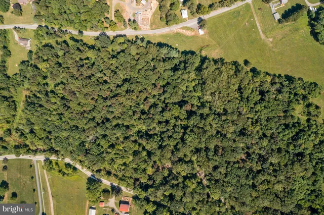 an aerial view of a houses with a yard