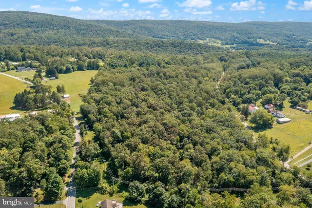 a view of a field with an ocean and mountain view