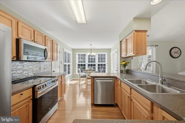 a kitchen with granite countertop white cabinets and a sink