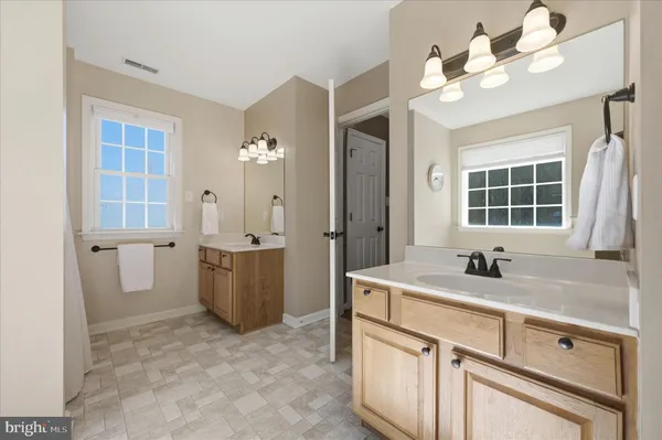a bathroom with a double vanity sink mirror and vanity