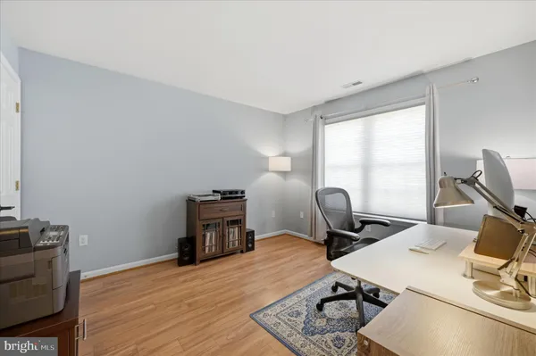 a view of a hallway with wooden floor and entryway