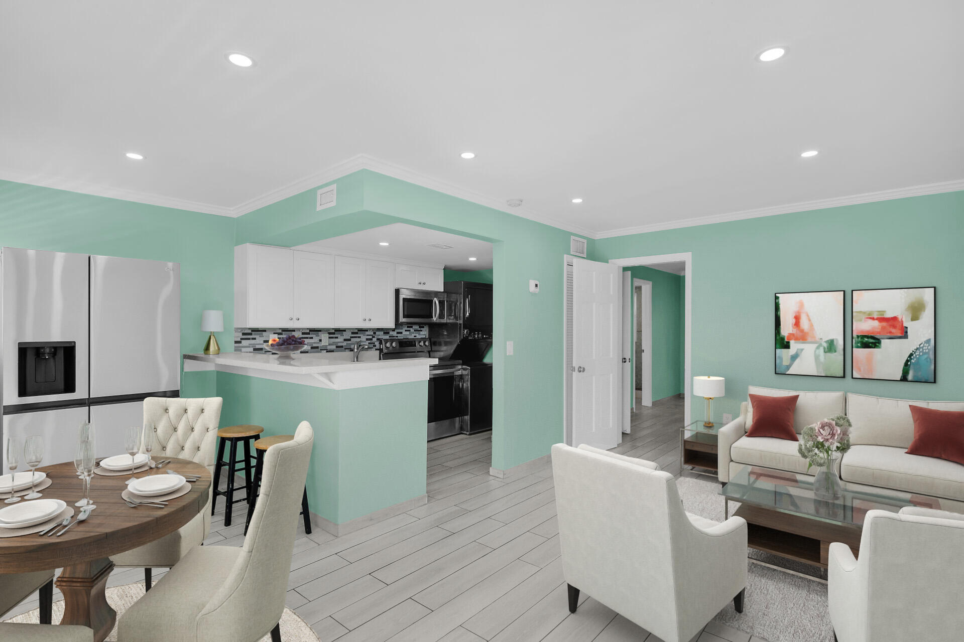 a living room with kitchen island furniture and a view of kitchen appliances
