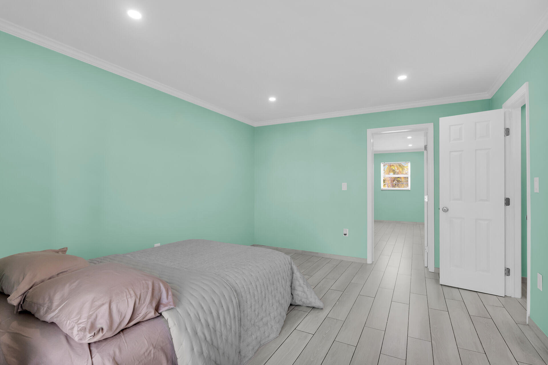 201 Coppitt Road, Unit 202C Key West, FL 33040 - Photo 16 of 31 a bedroom with a bed and wooden floor