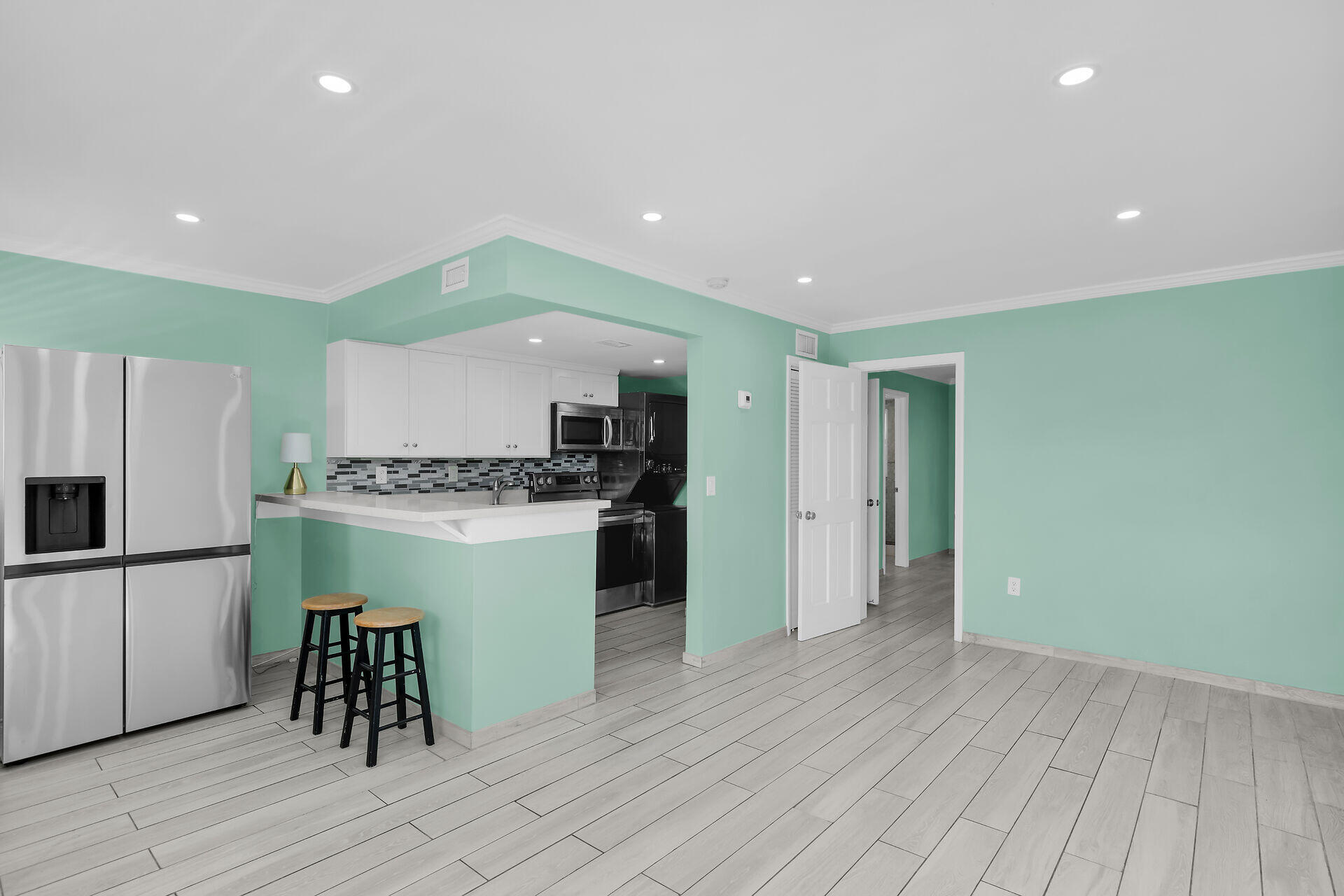 201 Coppitt Road, Unit 202C Key West, FL 33040 - Photo 4 of 31 a kitchen with a refrigerator and a stove top oven