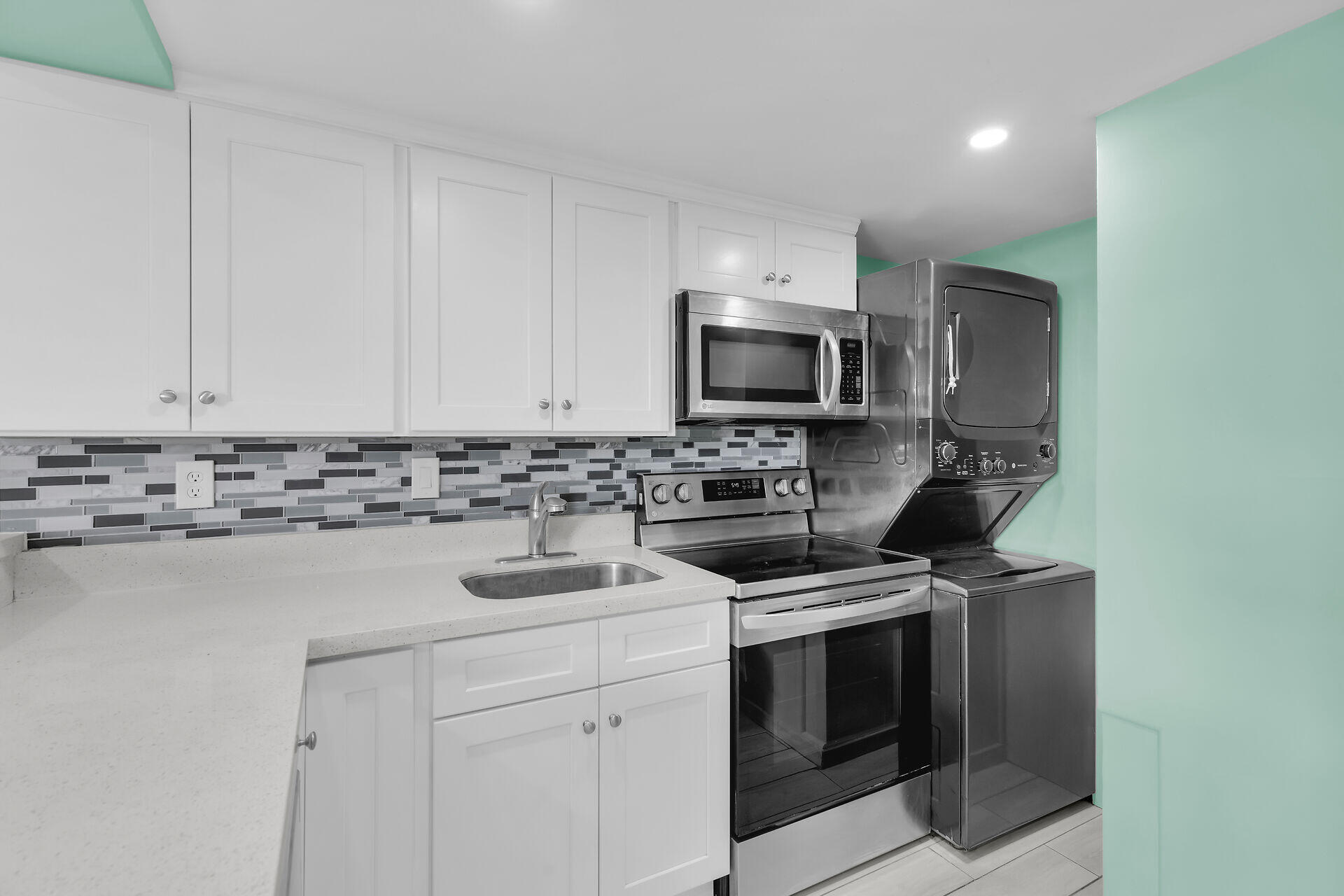 201 Coppitt Road, Unit 202C Key West, FL 33040 - Photo 10 of 31 a kitchen with appliances a sink and cabinets