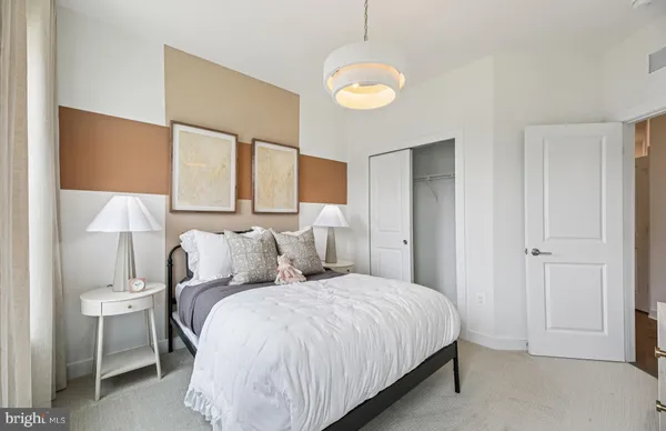 a bedroom with a bed and a chandelier