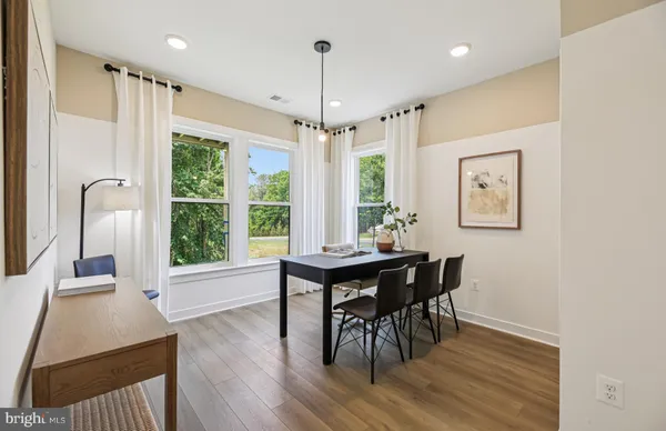 a view of a dining room with furniture window and wooden floor
