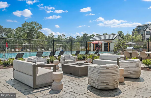 a view of a patio with couches chairs and a fire pit