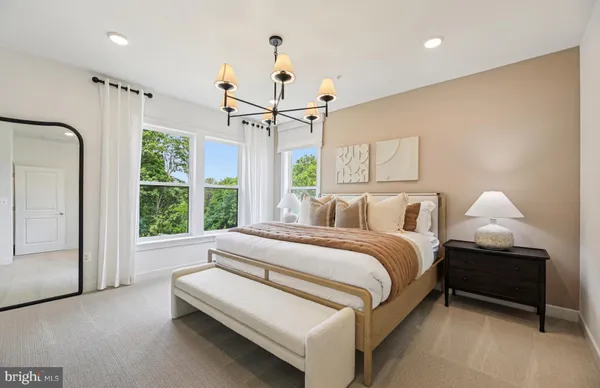 a spacious bedroom with a bed and a window