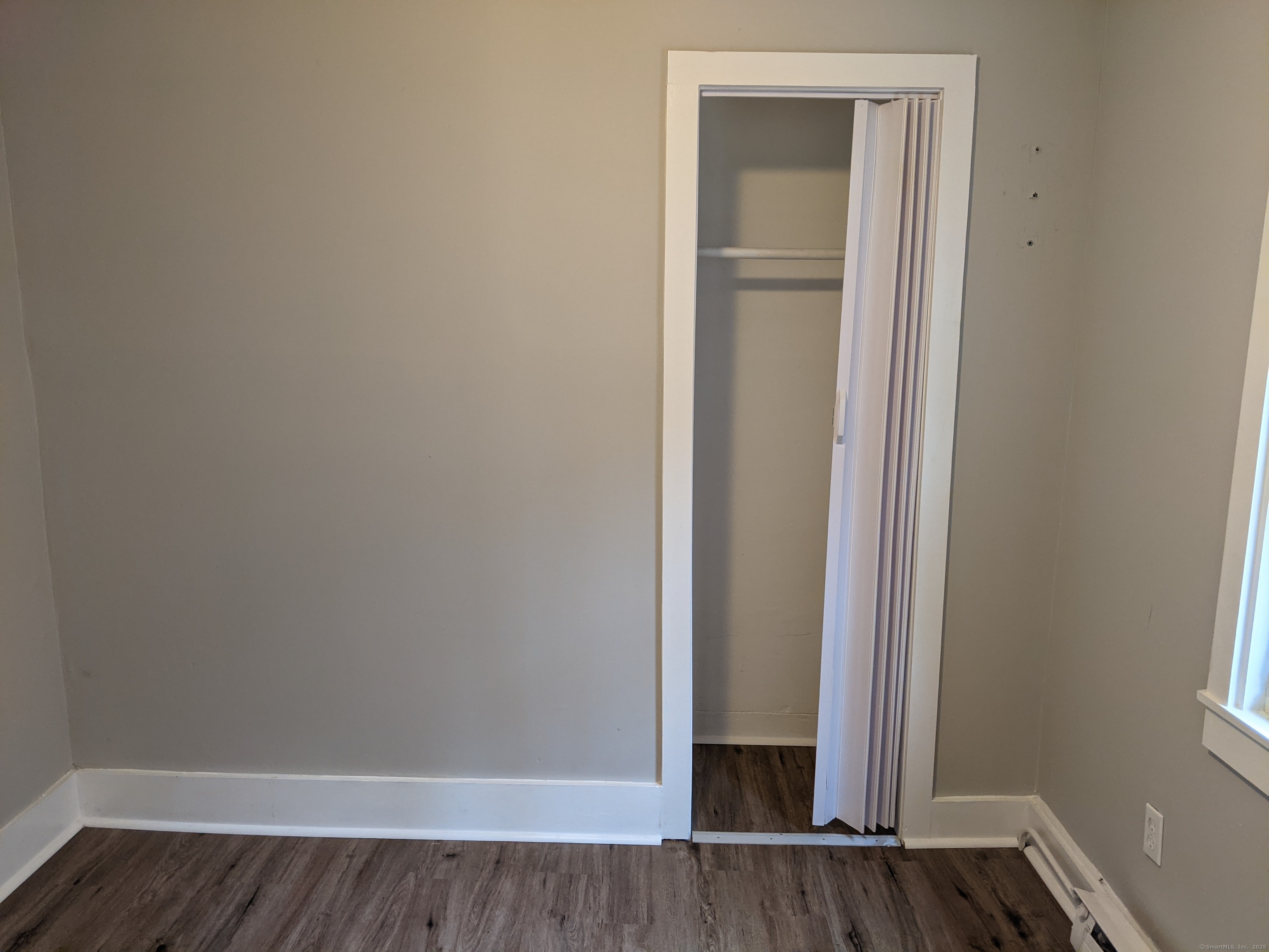 98 Water Street Derby, CT 06418 - Photo 11 of 15 a view of an empty room with wooden floor and a window
