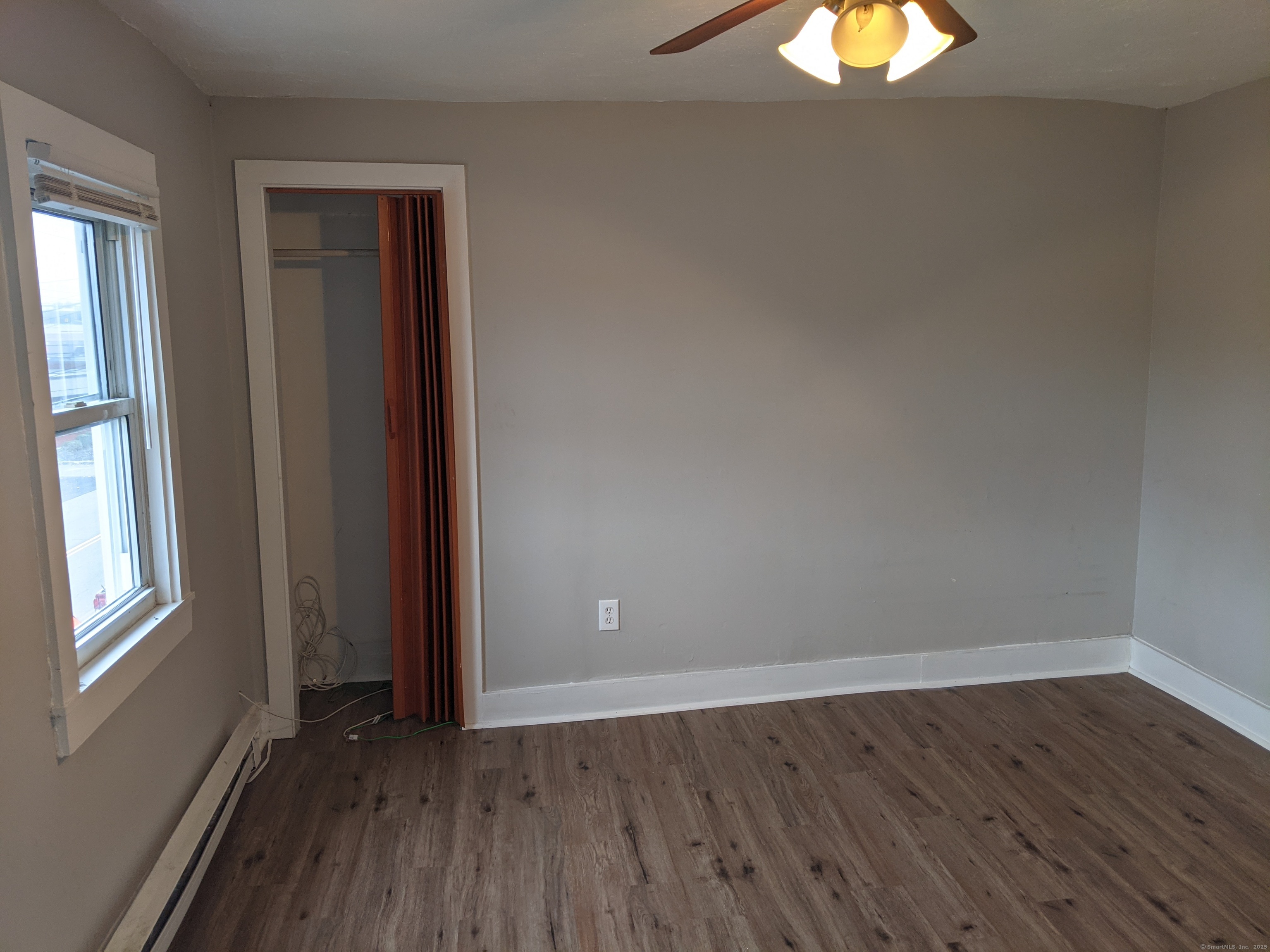 98 Water Street Derby, CT 06418 - Photo 12 of 15 an empty room with wooden floor and windows