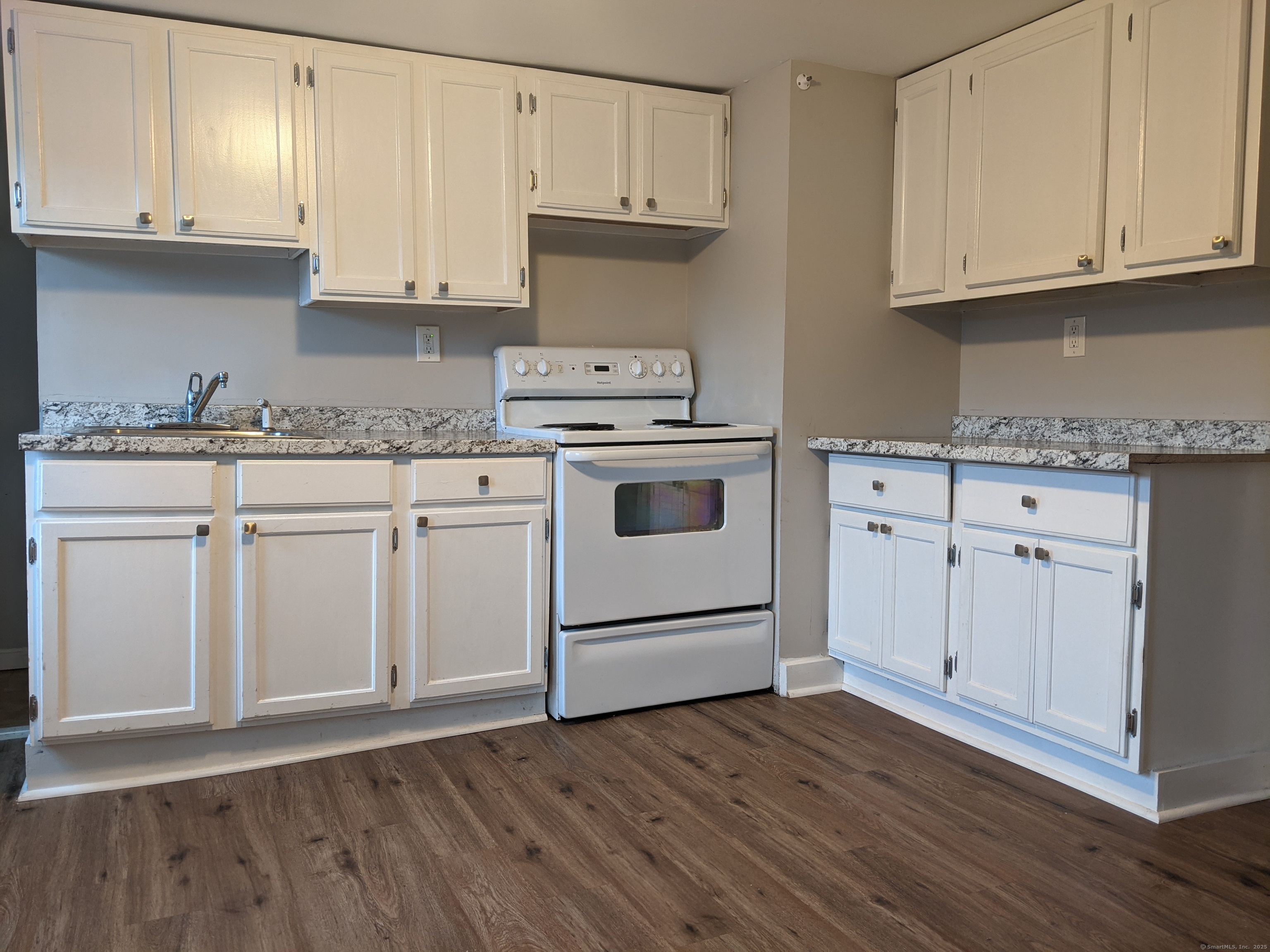 98 Water Street Derby, CT 06418 - Photo 6 of 15 a kitchen with granite countertop white cabinets and white appliances