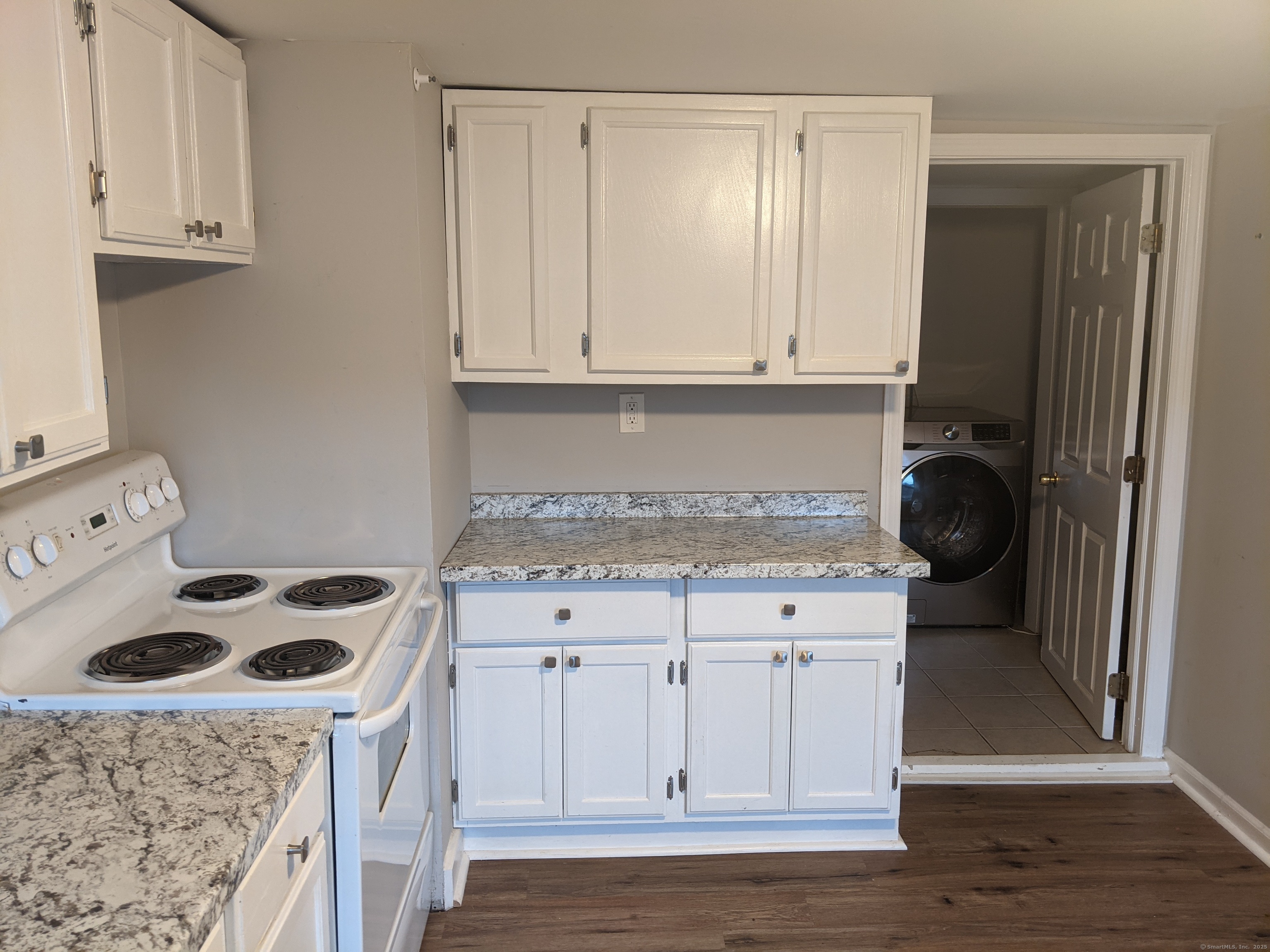 98 Water Street Derby, CT 06418 - Photo 9 of 15 a kitchen with granite countertop a sink a stove and cabinets