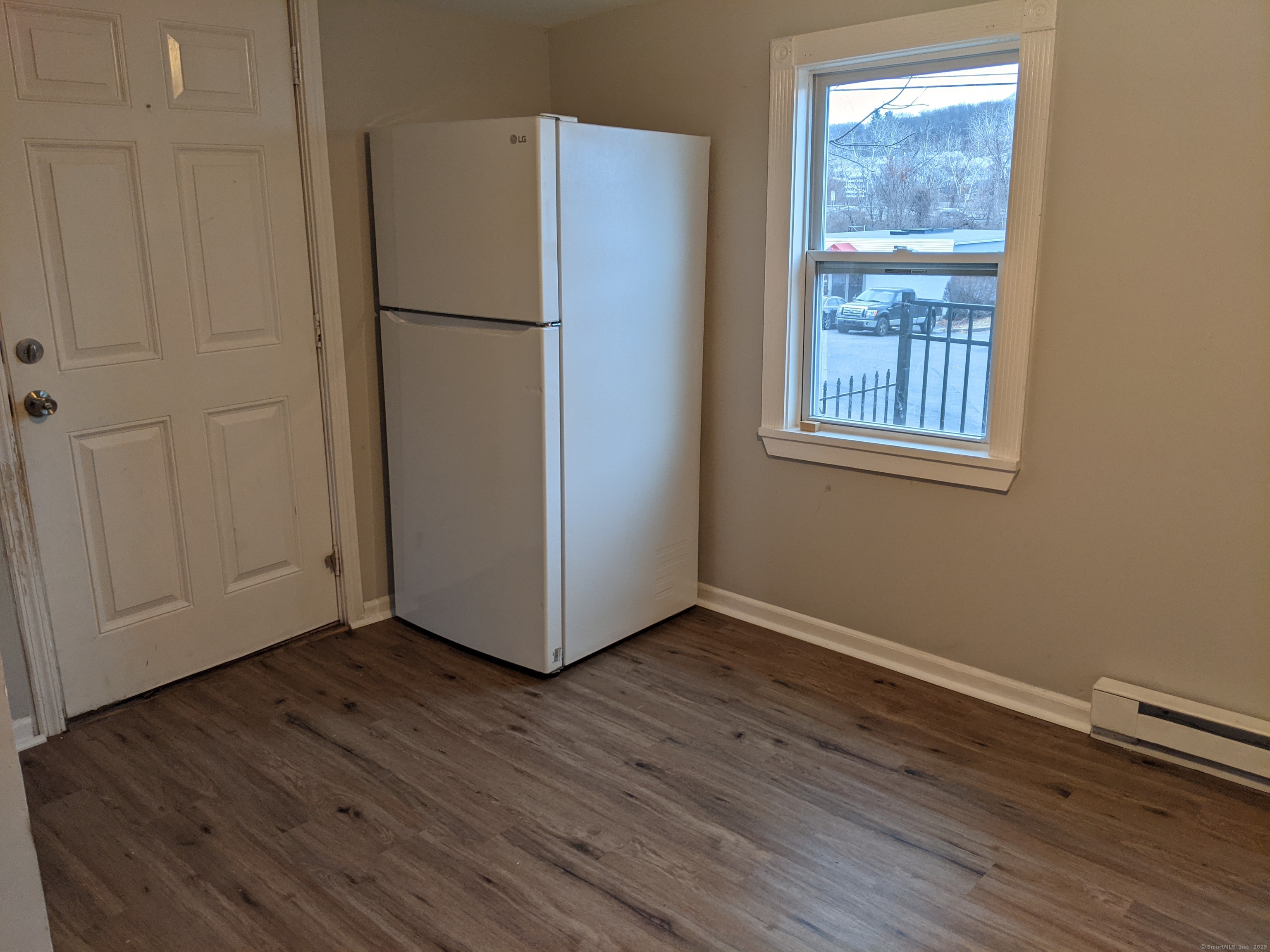 98 Water Street Derby, CT 06418 - Photo 10 of 15 a view of an empty room with wooden floor and a window