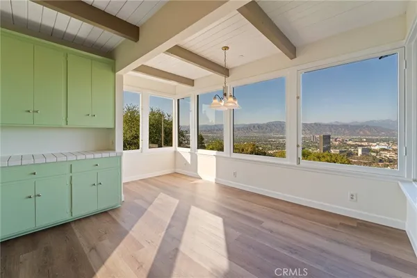 a view of a kitchen with wooden floor and furniture
