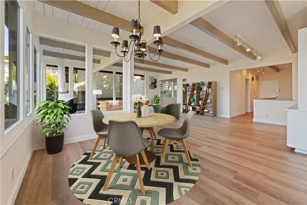 a view of a dining room with furniture and wooden floor