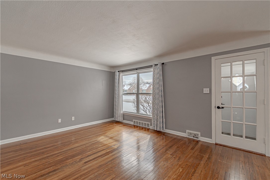 4157 Verona Road Cleveland, OH 44121 - Photo 10 of 26 Entryway with hardwood / wood-style floors and a textured ceiling