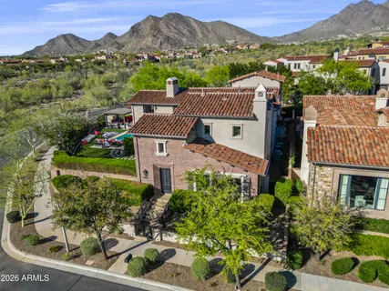 a kitchen with white cabinets and a wooden floor