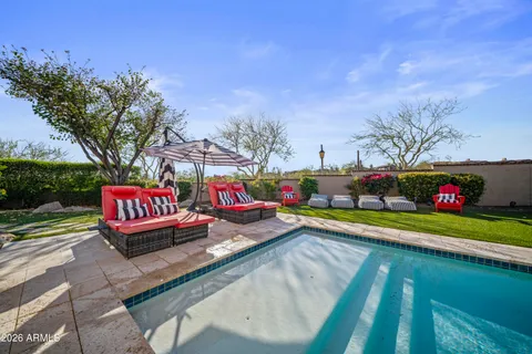 a bathroom with a toilet and a potted plant