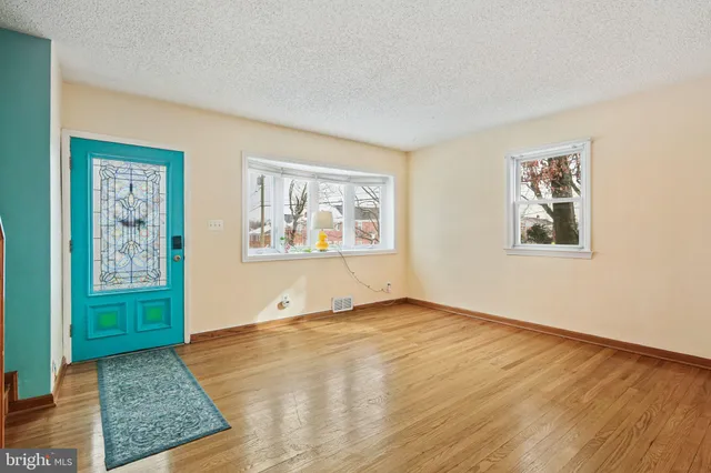 a view of an empty room with a window and closet