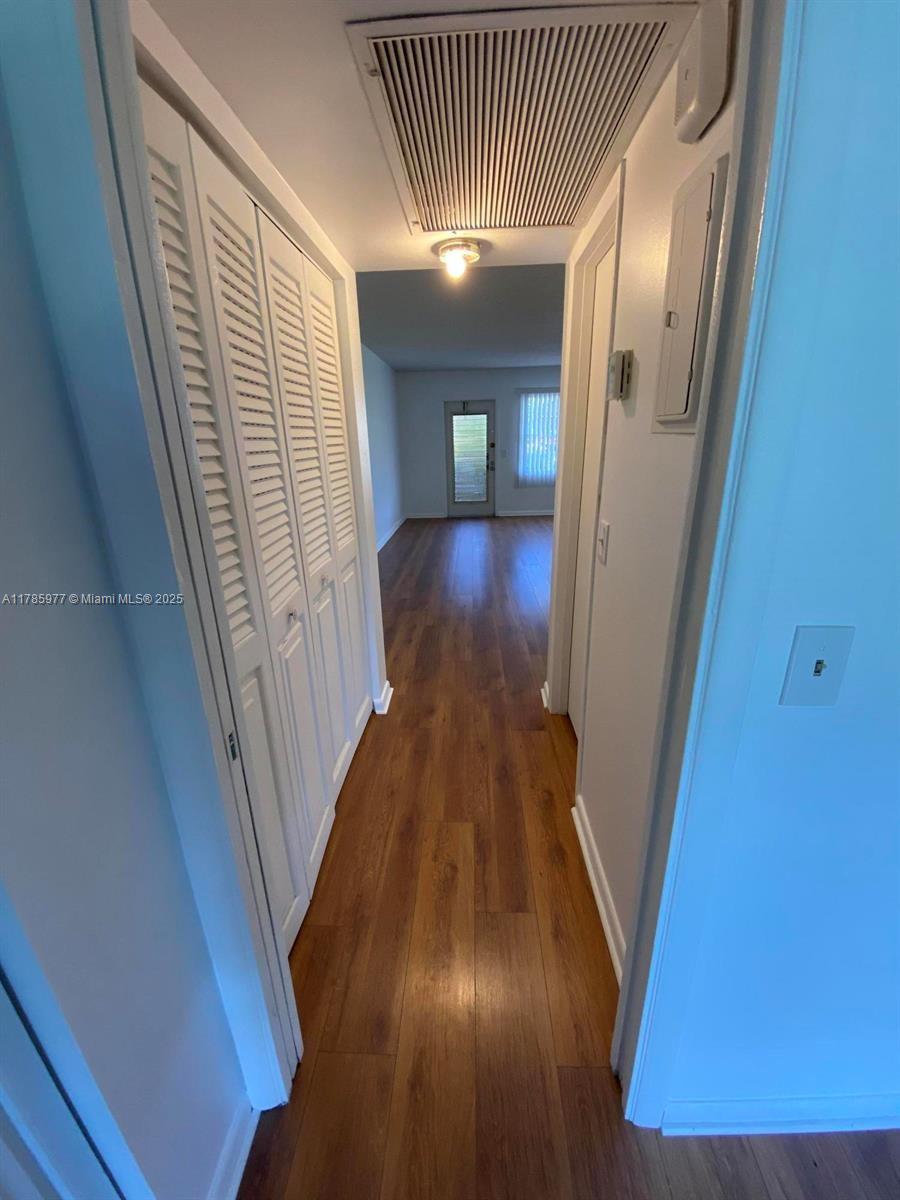 381 Fanshaw J, Unit 381 Boca Raton, FL 33434 - Photo 12 of 13 a view of a hallway with wooden floor and staircase